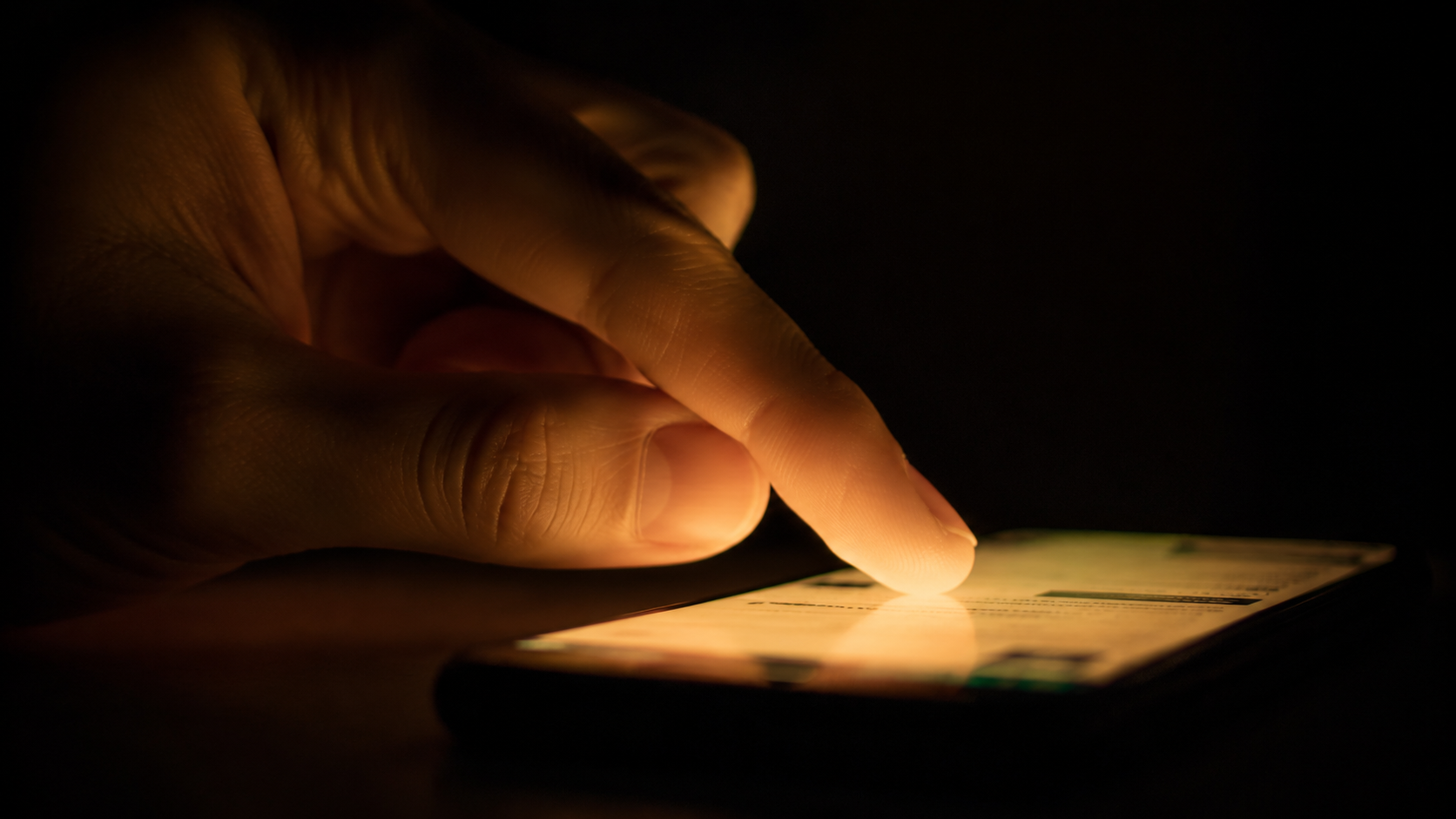 A hand touching a screen — the same gesture, a different wall
